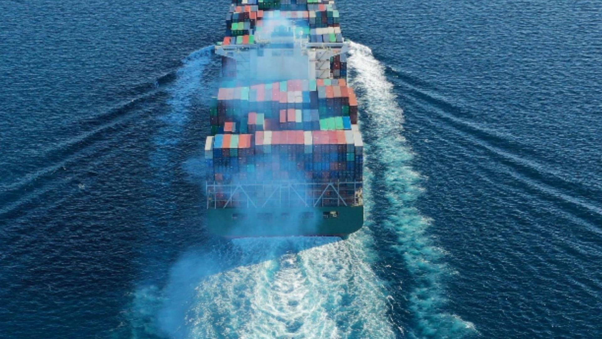 image of ship sailing with shipping crates
